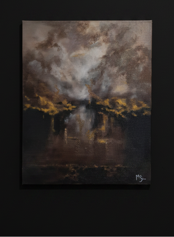 An textured painting of a dramatic stormy sky over dark water with golden light reflections, displayed on a solid black wall.